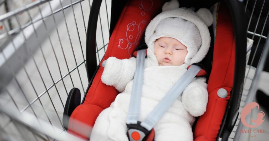 Parent carefully placing infant car seat into shopping cart basket.