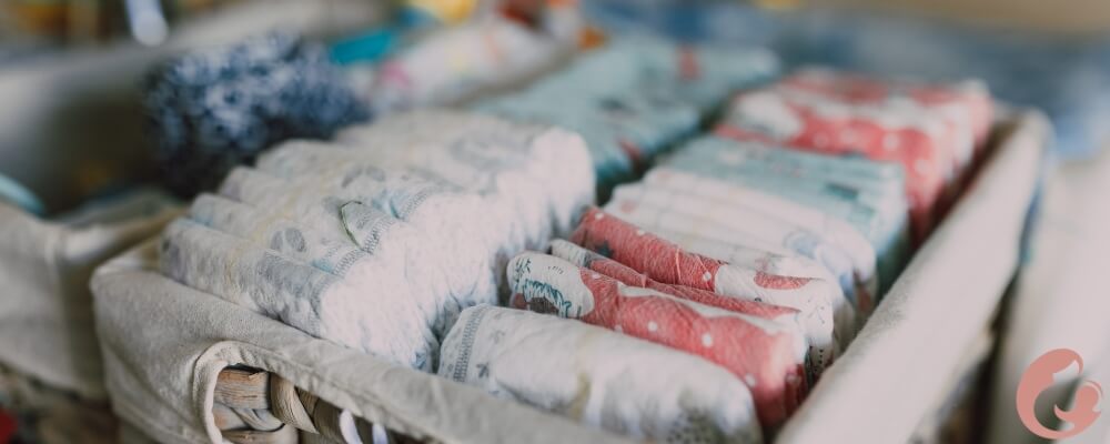 A parent changing a newborn's diaper on a changing table.